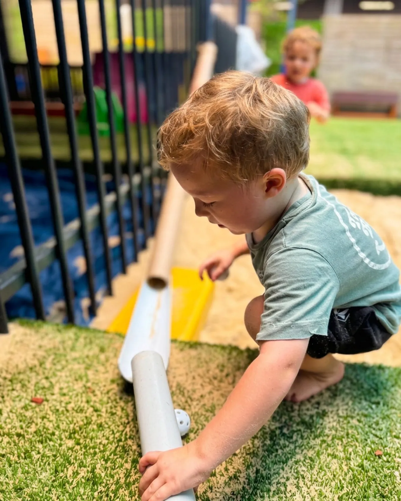 A child playing and building in the Global Explorers sandpit